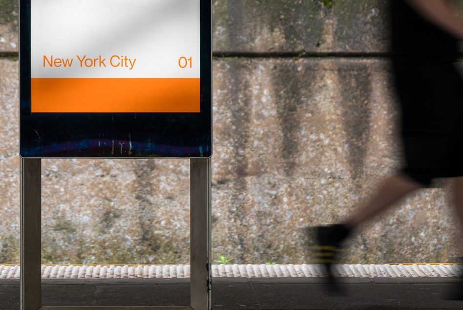 Blurry motion of a person walking past a clear signboard mockup with the text New York City 01, against a textured wall background.